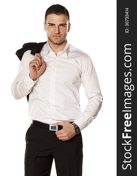 Serious young and attractive businessman in white shirt with a jacket over his shoulder, posing on a white background. Serious young and attractive businessman in white shirt with a jacket over his shoulder, posing on a white background