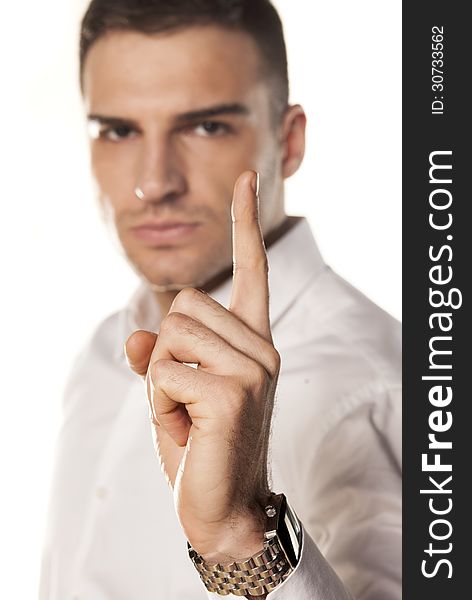 Angry attractive young man points a finger upwards