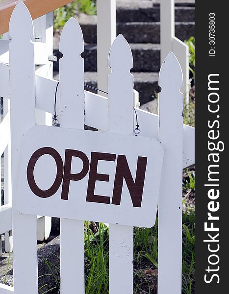 An open sign hanged outside a restaurant, store, office or other business (copy-space available for design)