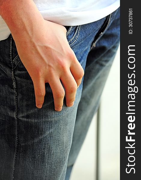 Detail of teenager with hand in his pocket. Detail of teenager with hand in his pocket