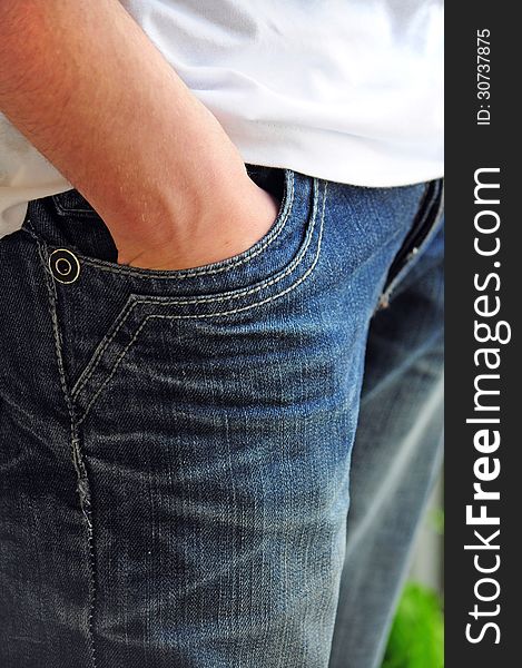 Detail of teenager with hand in trousers pocket. Detail of teenager with hand in trousers pocket