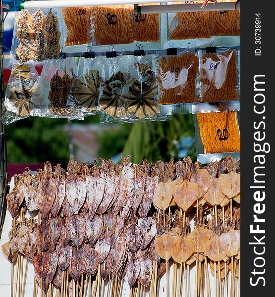 Dried squid skewers a row for sale. Dried squid skewers a row for sale.