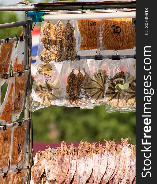 Dried squid skewers a row for sale. Dried squid skewers a row for sale.