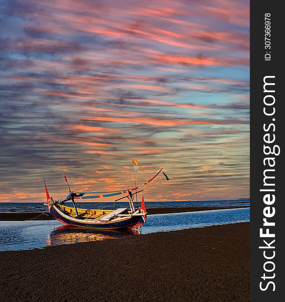 Boat in the beach and multy color cloud