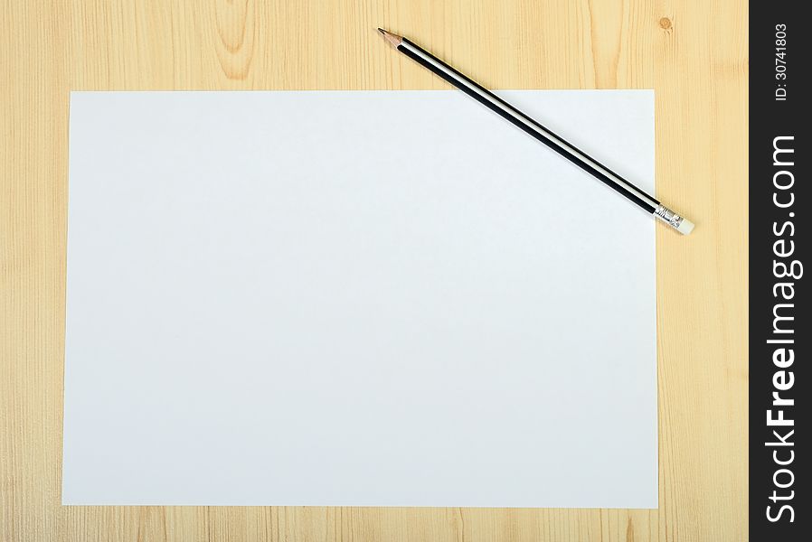 Blank Page Of Paper And Sharpened Pencil On Wooden Floor