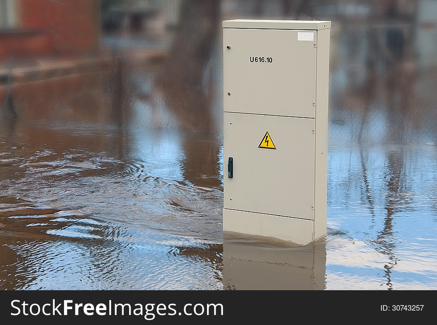 Dangerously swollen river flooded electrical cabinet