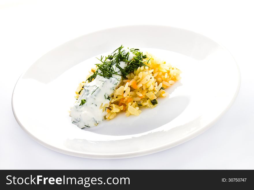 White rice with garlic sauce on a plate on white background