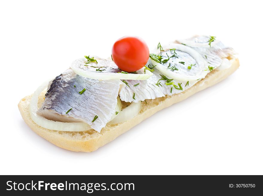 Sandwich with herring, onions, cherry tomato and herbs, isolated