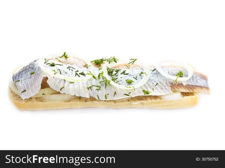 Sandwich with herring, onions and herbs, isolated