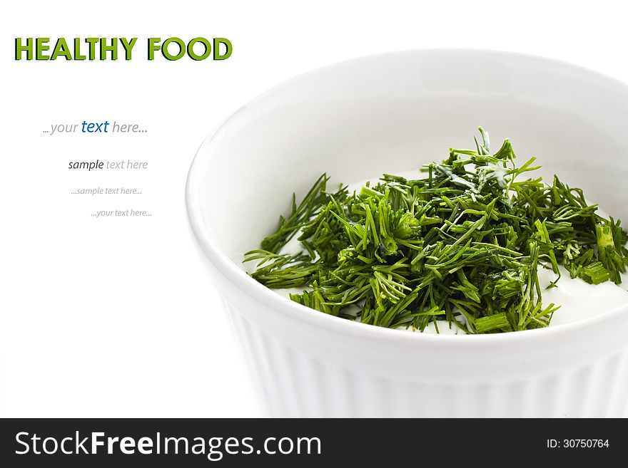 Sour cream in small round plate with herbs, isolated. With sample text
