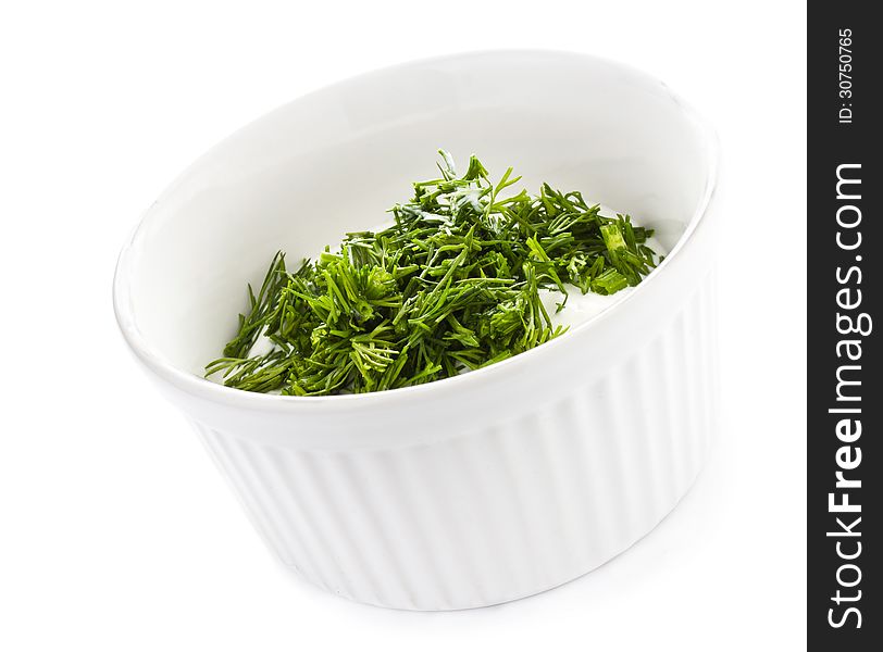 Sour cream in small round plate with herbs, isolated