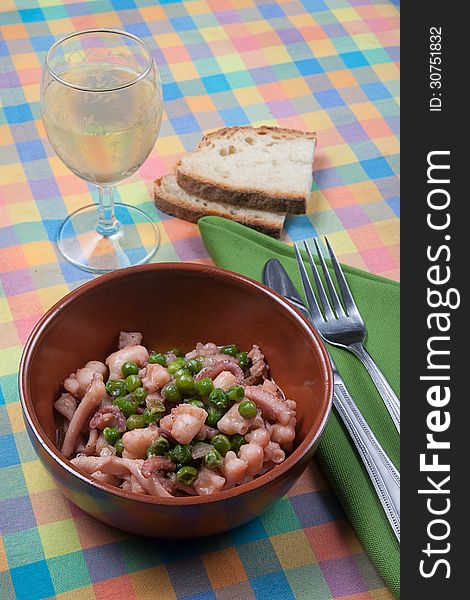 Dish of traditional Roman and Italian cuisine made from octopus, peas, onion and olive oil. Dish of traditional Roman and Italian cuisine made from octopus, peas, onion and olive oil