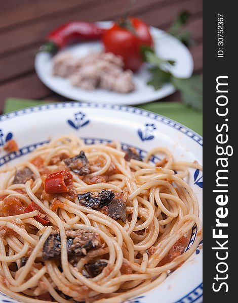 Typical dish of traditional Roman and Italian cuisine made from spaghetti pasta, dried mushrooms, tuna, onion, olive oil. Typical dish of traditional Roman and Italian cuisine made from spaghetti pasta, dried mushrooms, tuna, onion, olive oil
