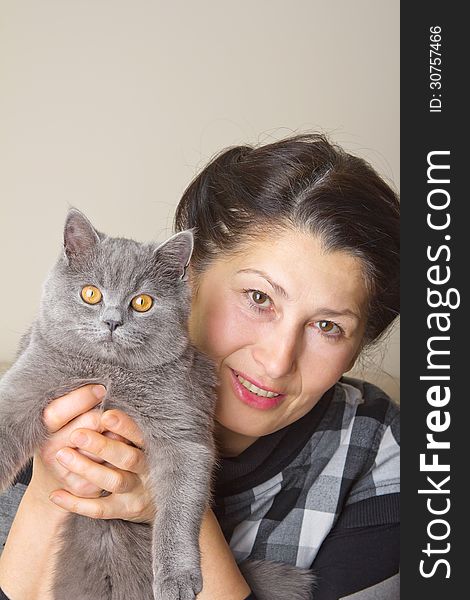 Pretty woman with a gray cat British breed. Pretty woman with a gray cat British breed