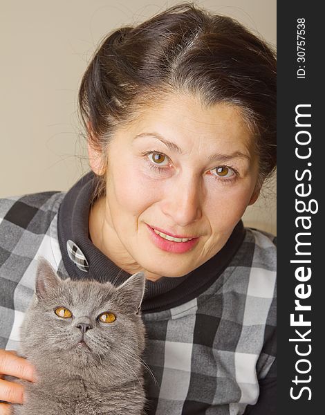 Pretty woman with a gray cat British breed. Pretty woman with a gray cat British breed