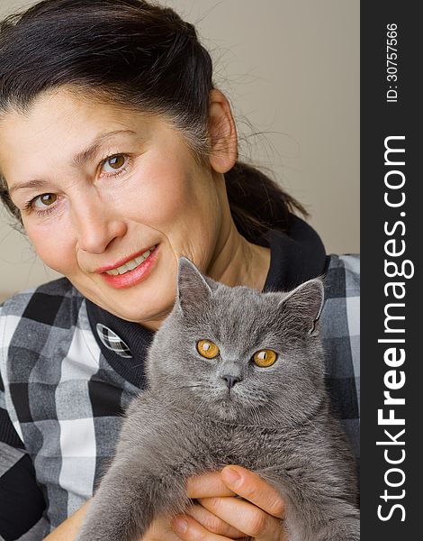 Pretty woman with a gray cat British breed. Pretty woman with a gray cat British breed