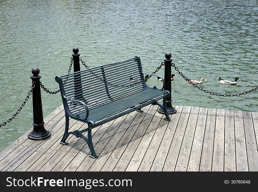 Iron garden bench at lakeside.