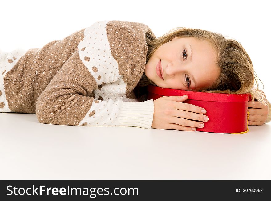 Beautiful girl lies on a gift box isolated