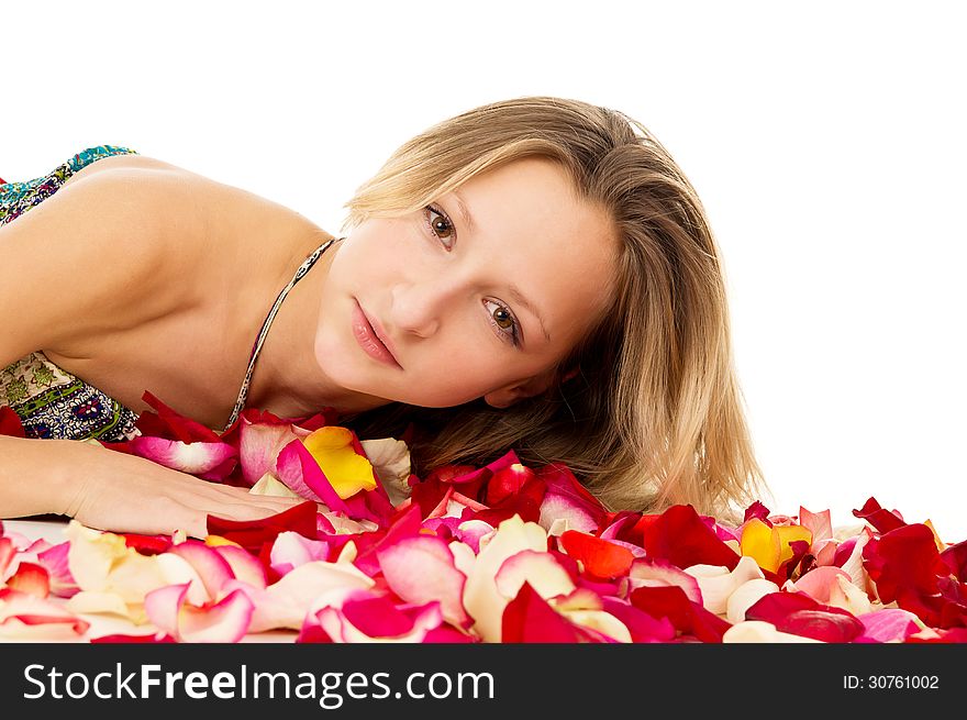 Beautiful girl lies in rose petals