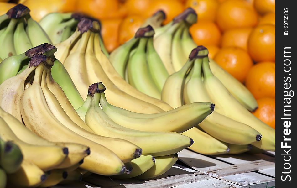 Fruit market with green-yellow bananas