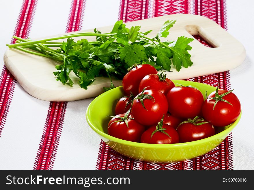 Tomatoes in a green bowl and parsley