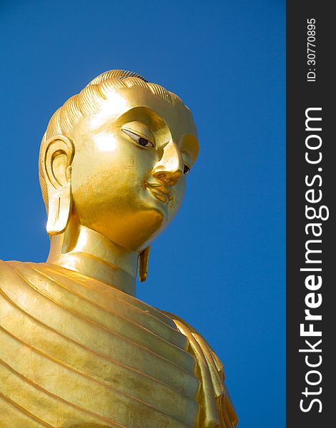 Gold buddha on blue sky