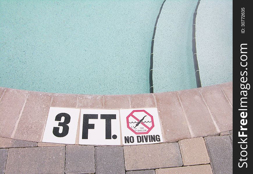 Shallow area of a pool. No Diving Sign.