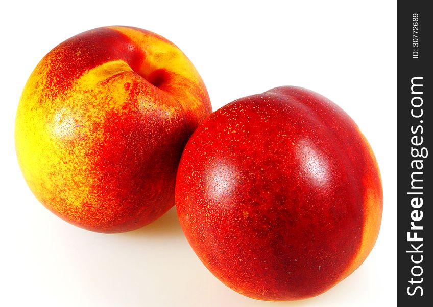 Two ripe apricots on a white background