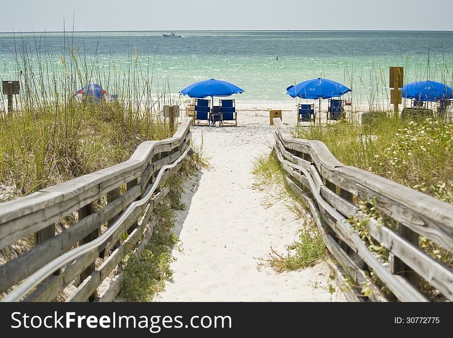 Wooden walkway goes out of a beach.