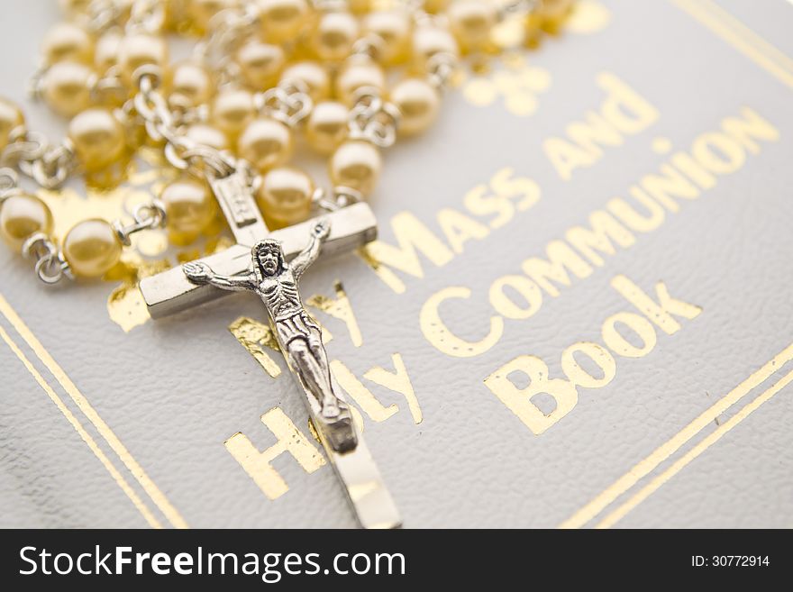 Closeup of a rosary on communion book. Closeup of a rosary on communion book.