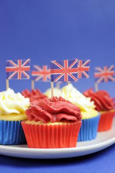 English Theme Red, White And Blue Cupcakes With Great Britain Union Jack Flags - Close Up Vertical. Stock Image