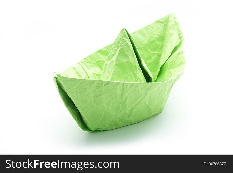 Green crumpled paper origami boat isolated on white. Green crumpled paper origami boat isolated on white