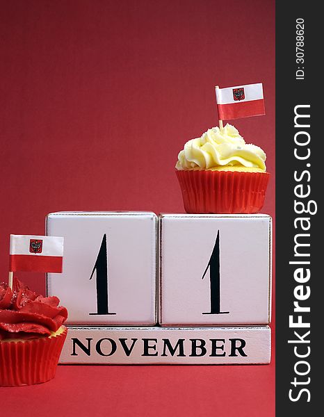 Calendar date for Poland National Independence Day, November 11, with mini cup cakes and Polish flags in red and white theme colors. Calendar date for Poland National Independence Day, November 11, with mini cup cakes and Polish flags in red and white theme colors.