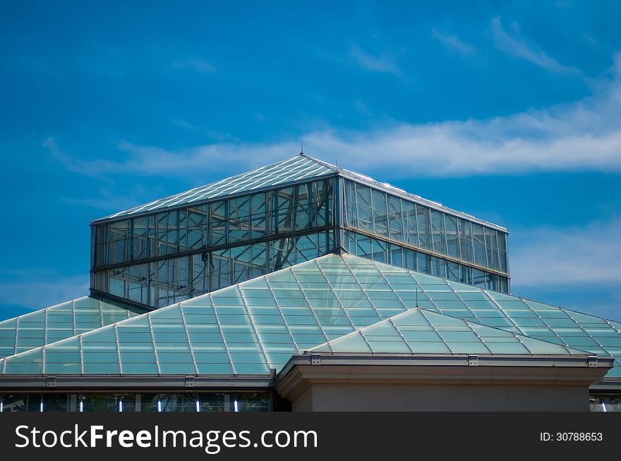 Blue glass roof structure and sky. Blue glass roof structure and sky