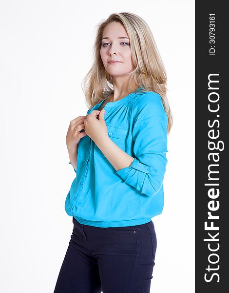 Beautiful blonde in a blue blouse and pants rehearsing a photo shoot. Beautiful blonde in a blue blouse and pants rehearsing a photo shoot