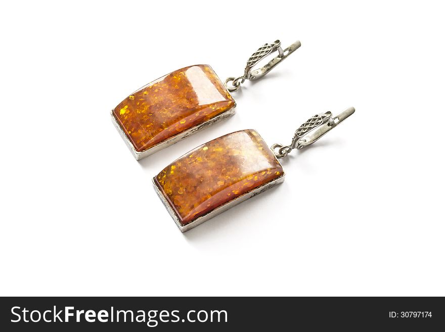 Old massive amber earrings over white