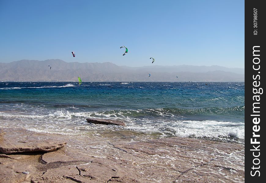 Windsurfers and kites on the beach of Red Sea, Eilat, Israel. Windsurfers and kites on the beach of Red Sea, Eilat, Israel