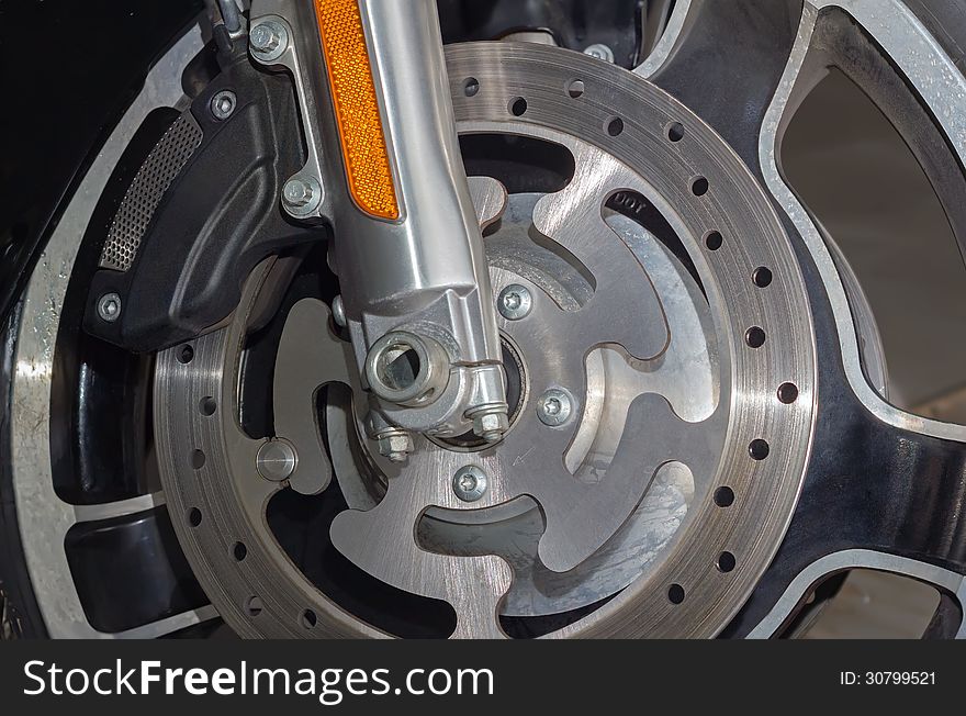 Closeup detail of a motorcycle's front brake and wheel. Closeup detail of a motorcycle's front brake and wheel