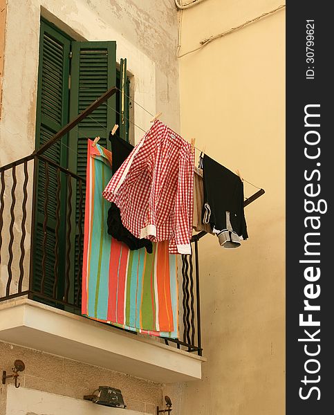 Italian balcony with hanging clothes