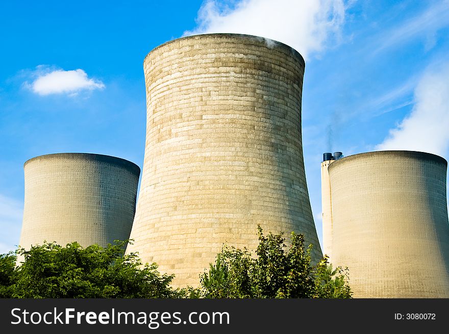 Three power station cooling towers and chimney