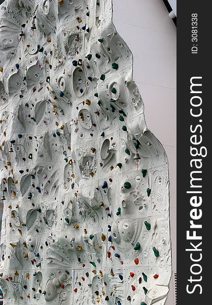 A grey climbing wall from the side