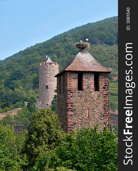 A medieval tower in alsace with a storks nest on the top. A medieval tower in alsace with a storks nest on the top