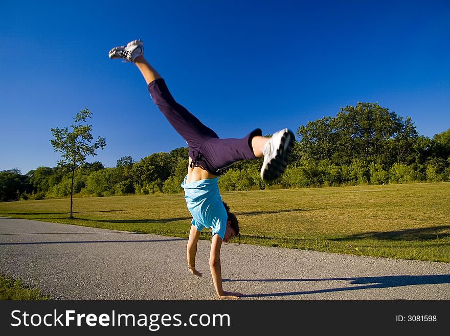 Woman doing cartwheel in park