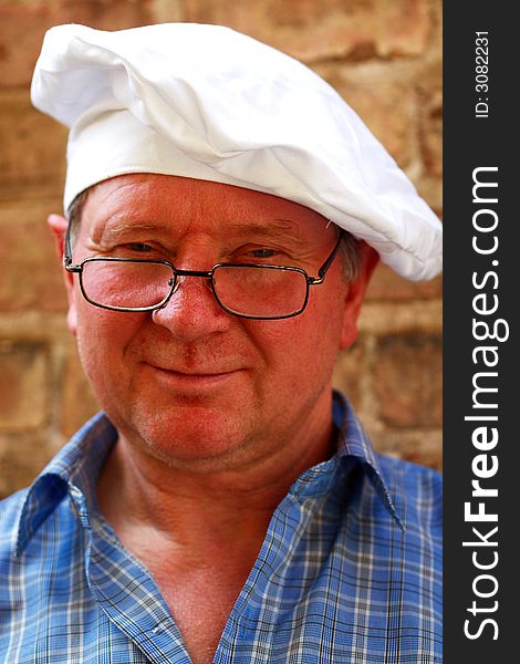 Portrait of a cook on the brick wall