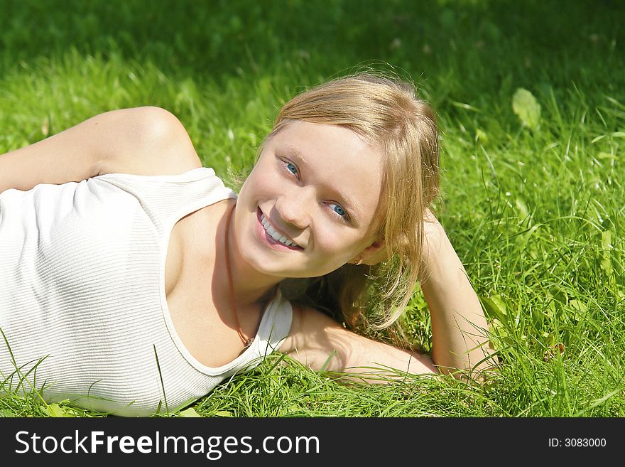 Smiling girl lying on grass