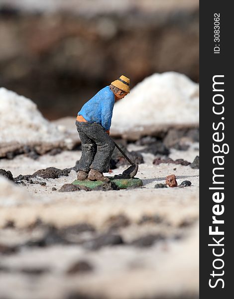 Miniature worker in a salt harvest field