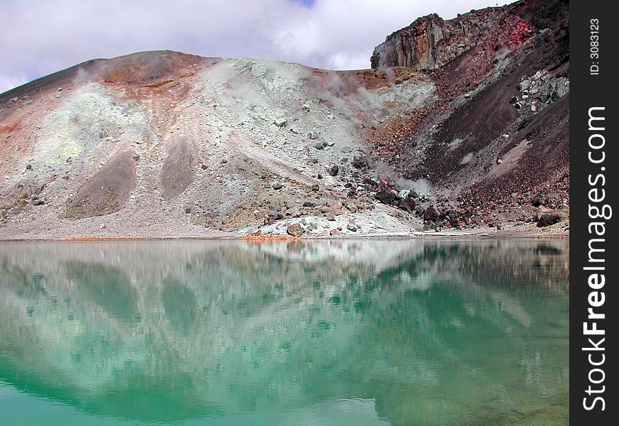 Colored mountain reflected in water