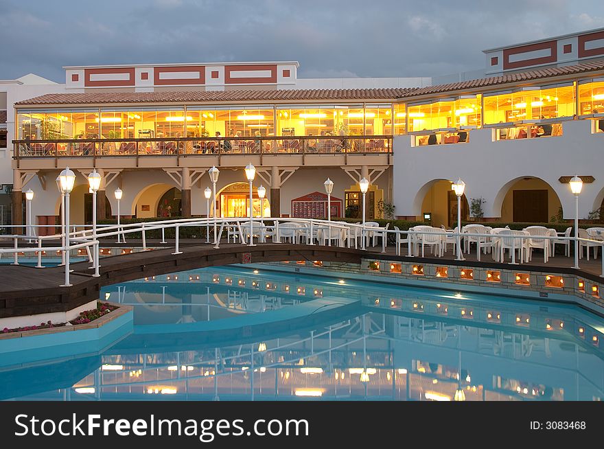 Restaurant and swimming pool with foot bridge in resort