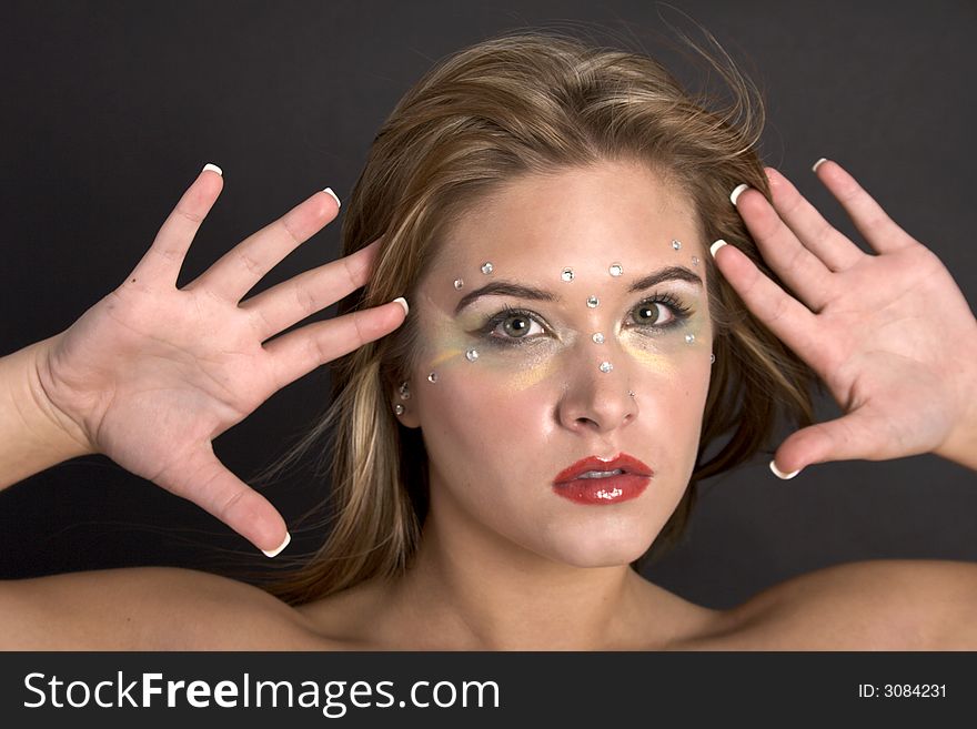 Closeup of a pretty young woman holding her outstretched hands near her face. Closeup of a pretty young woman holding her outstretched hands near her face