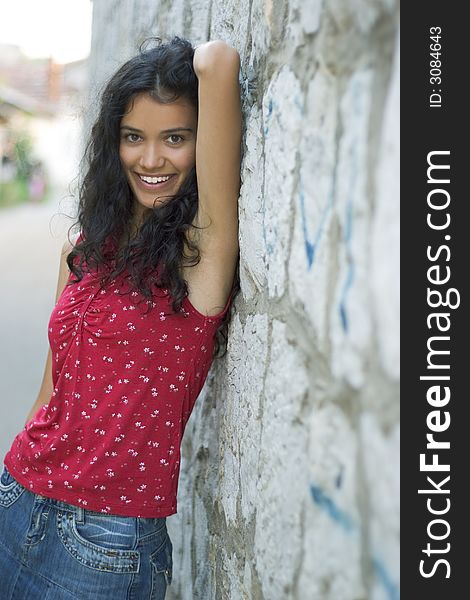 Beautiful smiling young woman in red on street. Beautiful smiling young woman in red on street